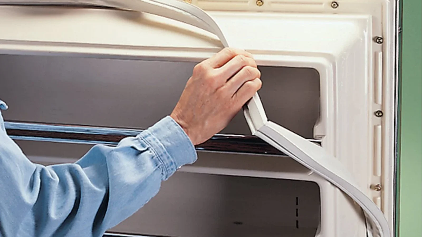How to repair a freezer door seal with visible gaps and worn gasket edges
